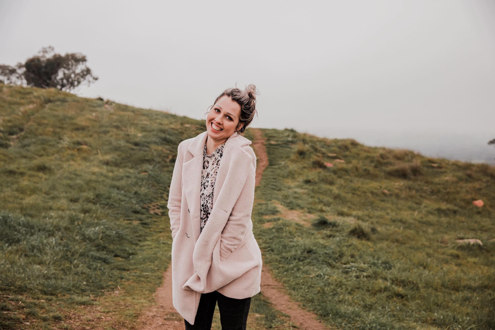 Jodie greck photographer in albury smiling looking at the camera cold on huon hill for her photography brand photo for heartfully cptured as a family photographer